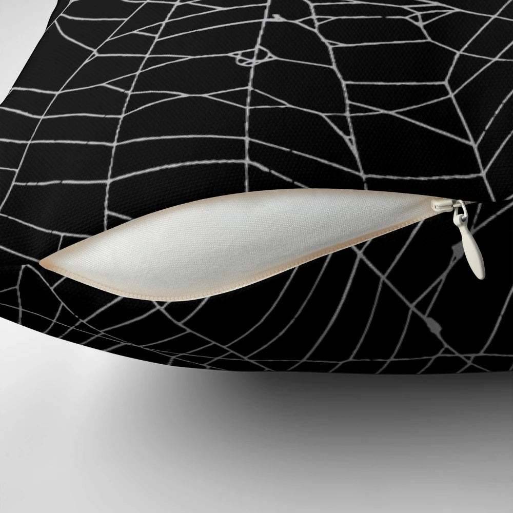 Black and white spiderweb pattern pillow with a detailed, distressed design.