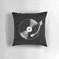 A black and white circular throw pillow with a spinning record design, perfect for music enthusiasts.