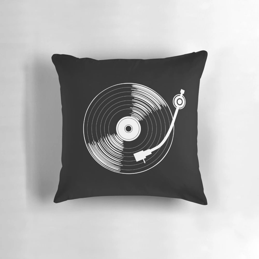 A black and white circular throw pillow with a spinning record design, perfect for music enthusiasts.