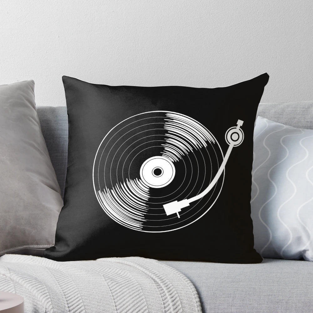 A black and white circular throw pillow with a spinning record design, perfect for music enthusiasts.