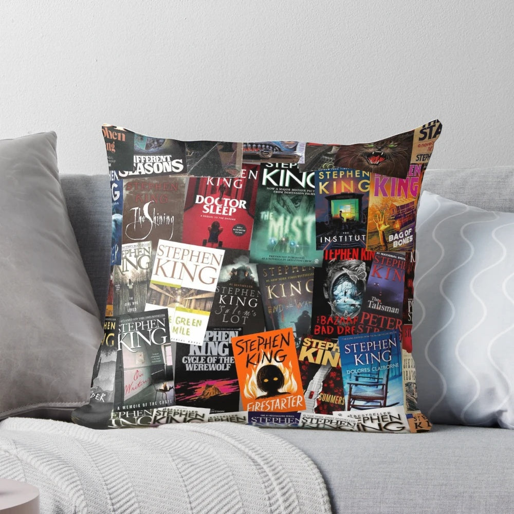 A decorative pillow featuring various horror book covers, including works by Stephen King such as Carrie, The Dark Tower, and IT.