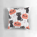A cozy, spooky-themed pillow with a cute cat and pumpkin pattern