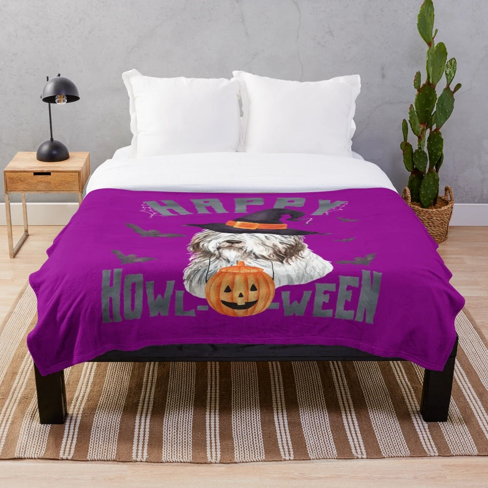 Bearded collie dog in a Halloween costume on a plush blanket