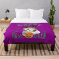 Bearded collie dog in a Halloween costume on a plush blanket