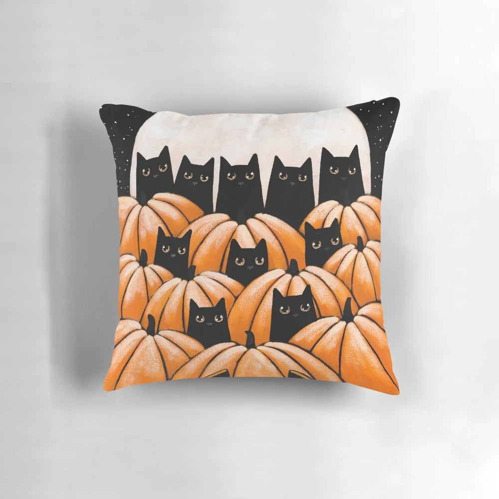 Black cats sitting among pumpkins in a pumpkin patch, halloween-themed decorative pillow