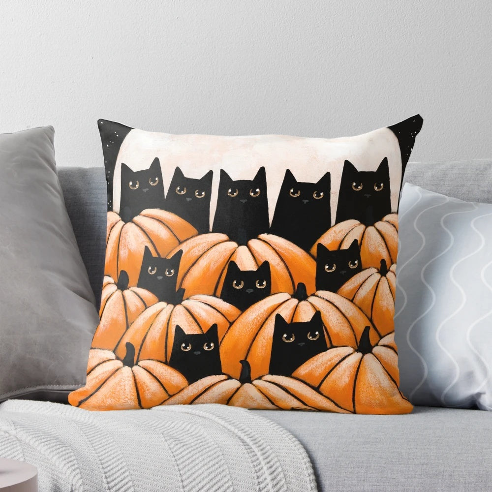Black cats sitting among pumpkins in a pumpkin patch, halloween-themed decorative pillow