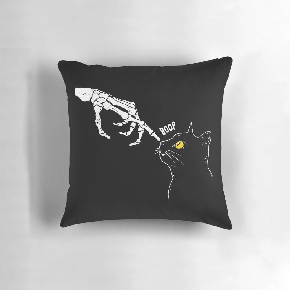 A spooky yet cute cat skeleton pillow with a "boop" graphic, perfect for Halloween and pet lovers.