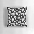 Decorative pillow featuring a pattern of cute cats and skulls, perfect for Halloween and spooky home decor