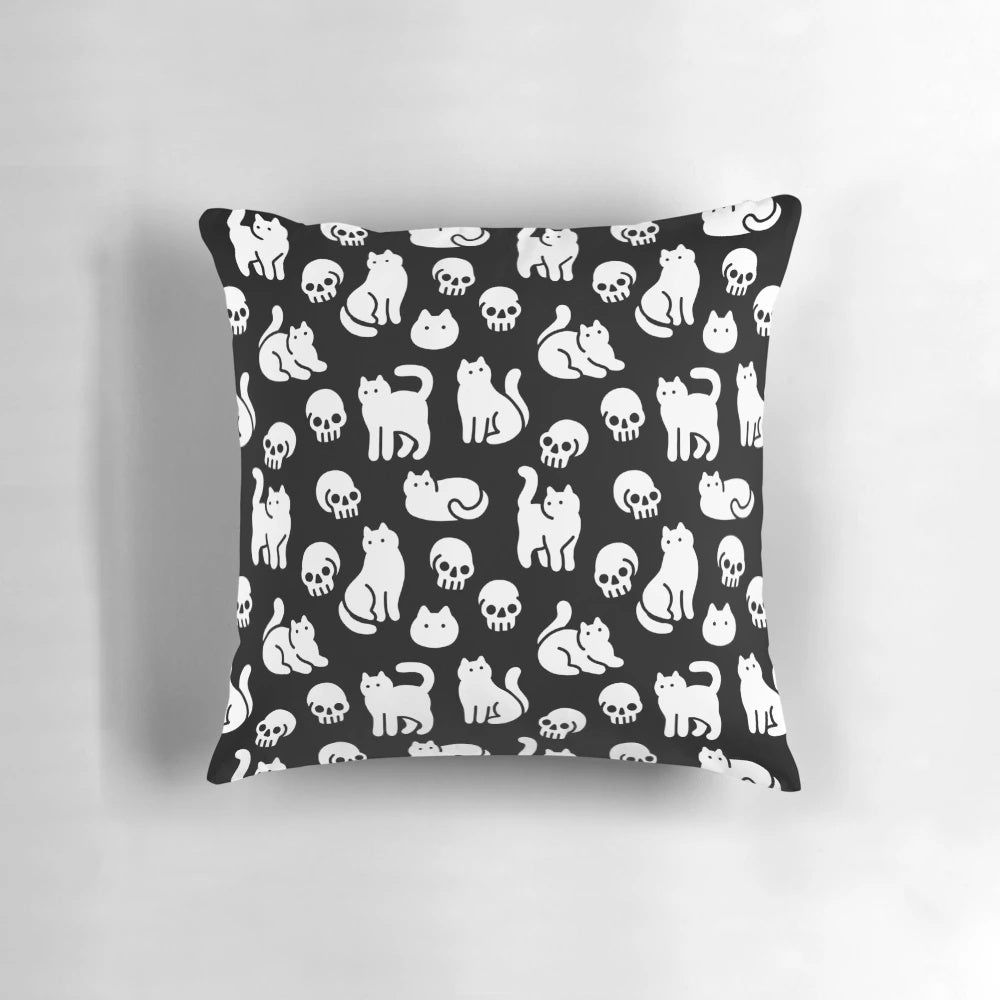 Decorative pillow featuring a pattern of cute cats and skulls, perfect for Halloween and spooky home decor