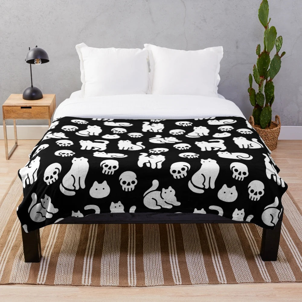 Plush blanket with cats and skulls pattern