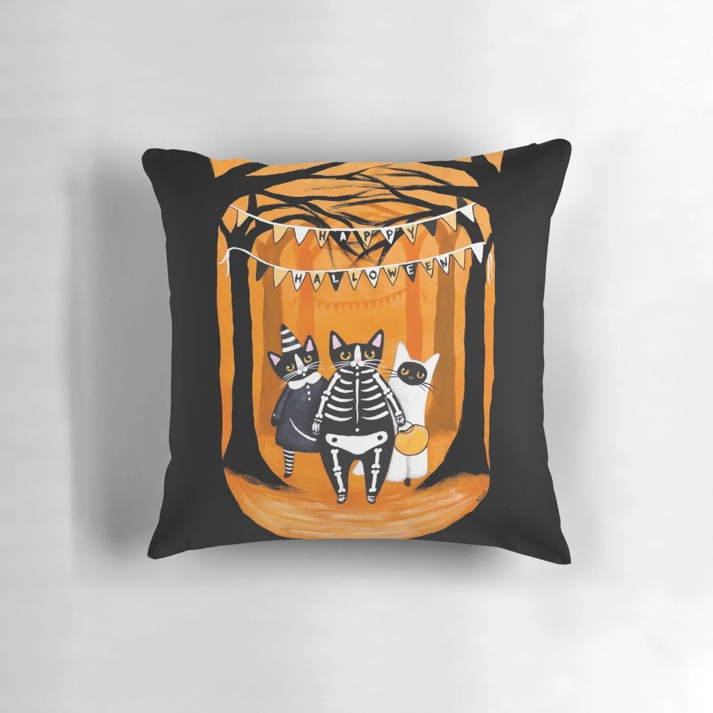 A cozy Halloween pillow featuring spooky cats, skeletons, ghosts, and a haunting forest scene.