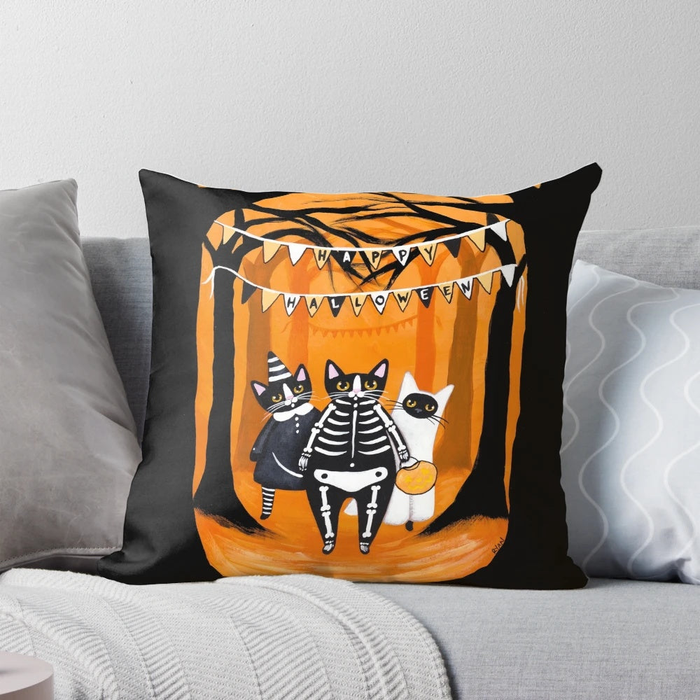 A cozy Halloween pillow featuring spooky cats, skeletons, ghosts, and a haunting forest scene.