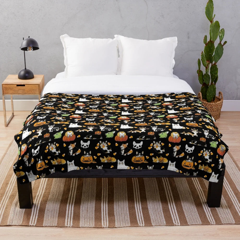 Corgi wearing a Halloween costume on a black plush blanket