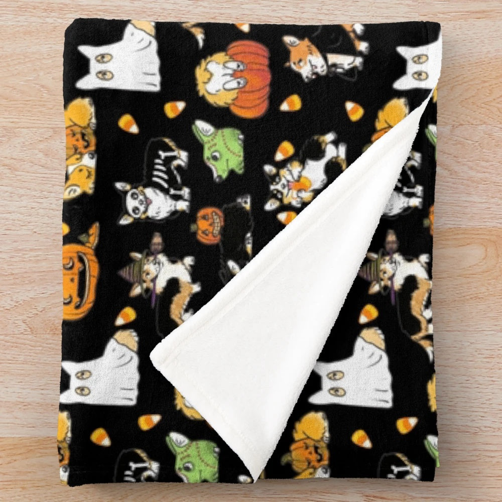 Corgi wearing a Halloween costume on a black plush blanket