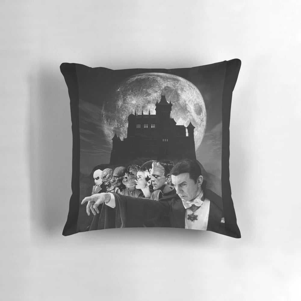 Decorative pillow featuring iconic horror movie characters like Dracula, Frankenstein, and the Wolfman