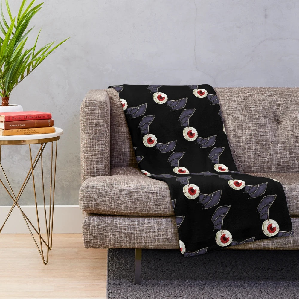 Cozy plush blanket with spooky eyebat design for gothic home decor