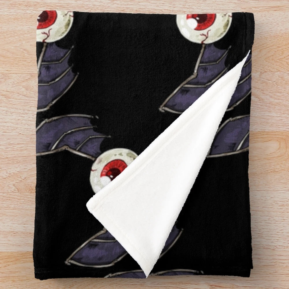Cozy plush blanket with spooky eyebat design for gothic home decor