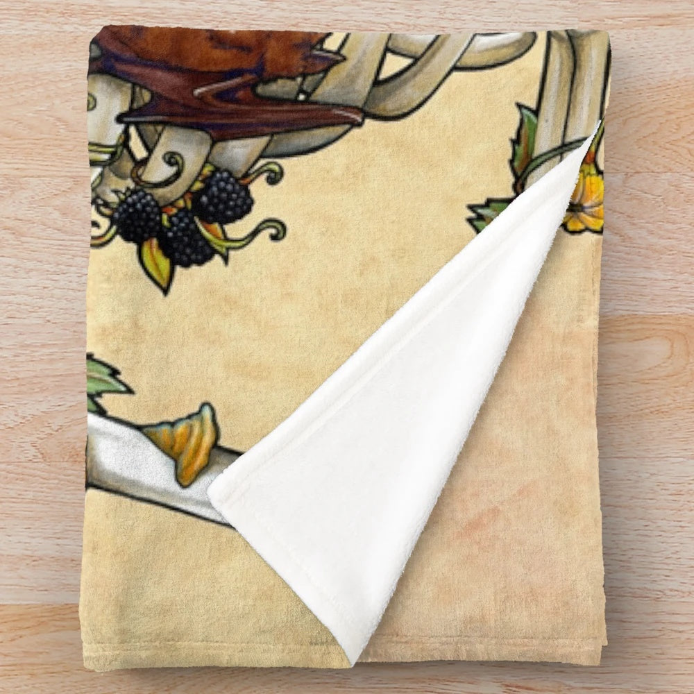 Plush blanket featuring a skeleton design with botanical elements including flowers and plants