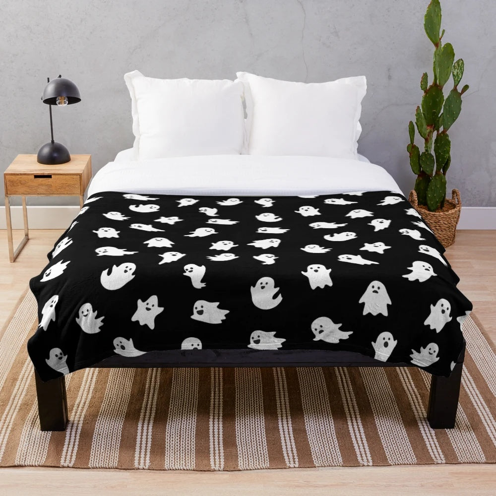 Cute ghosts pattern on a plush black blanket for Halloween and fall