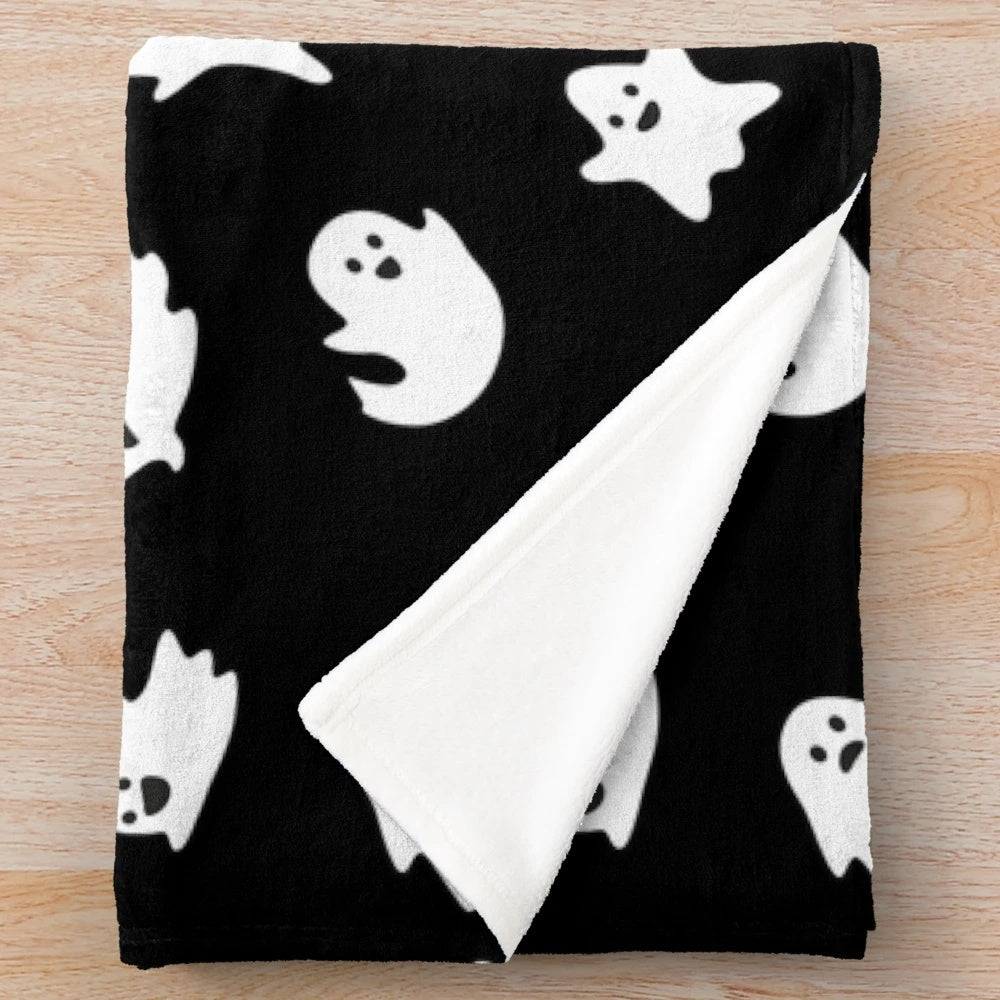 Cute ghosts pattern on a plush black blanket for Halloween and fall