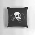 A black cat pillow with a spooky, gothic skull design