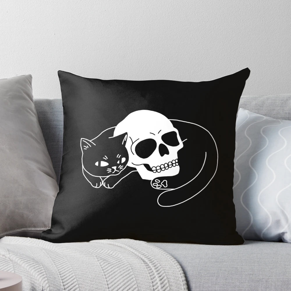 A black cat pillow with a spooky, gothic skull design