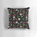 A gothic-style Christmas pillow featuring skulls, holly, and a moody black and red pattern.