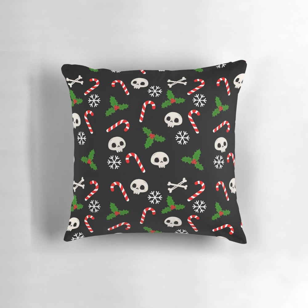 A gothic-style Christmas pillow featuring skulls, holly, and a moody black and red pattern.