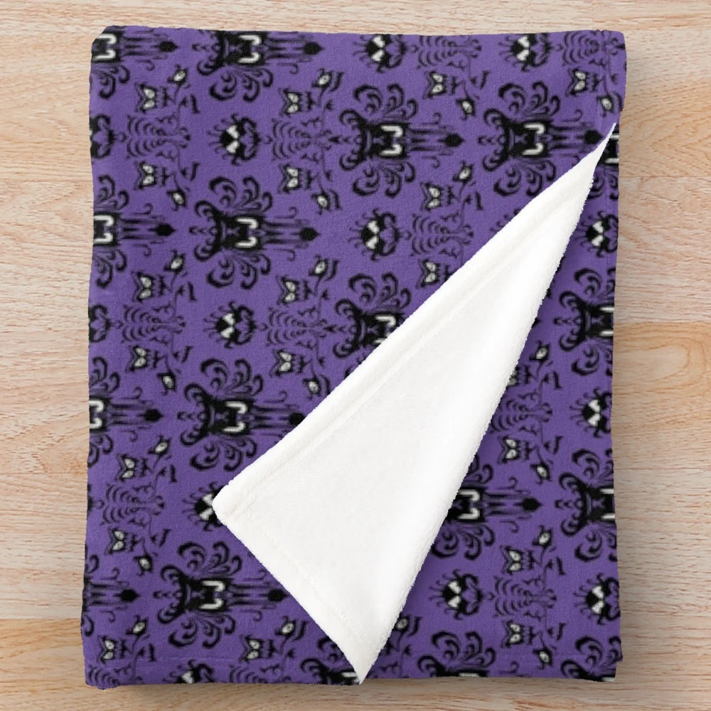Haunted Mansion themed plush blanket with dark purple damask pattern