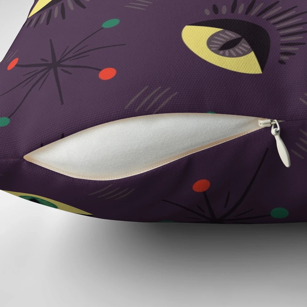 Decorative witch-themed pillow with a retro pattern featuring reptile and ghost eyes in shades of purple and black for a spooky, Halloween vibe.