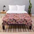 Plush blanket featuring a pattern of horror-themed cats