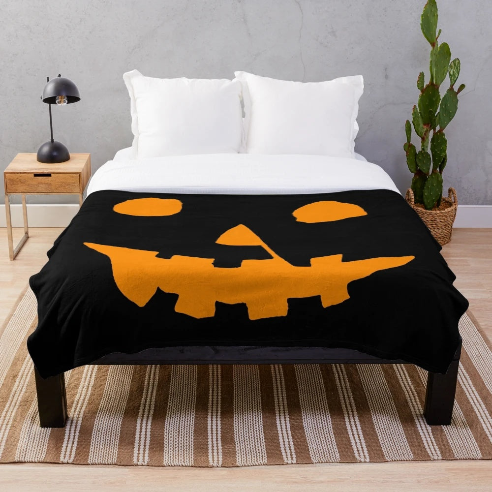 Cozy plush blanket featuring a Jack-O'-Lantern design for Halloween and horror movie enthusiasts