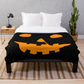 Cozy plush blanket featuring a Jack-O'-Lantern design for Halloween and horror movie enthusiasts