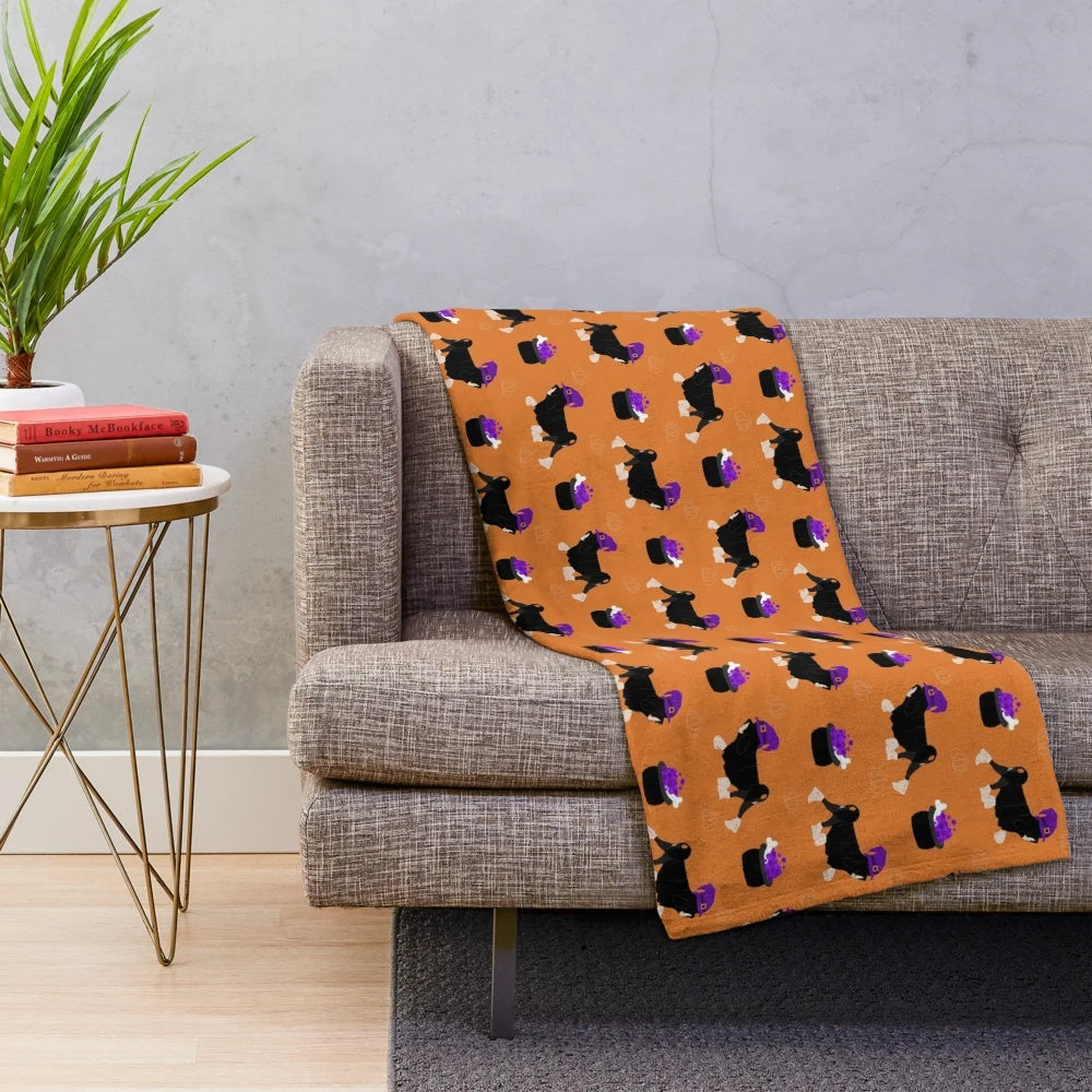 Spooky lowchen dog on a black and silver plush blanket