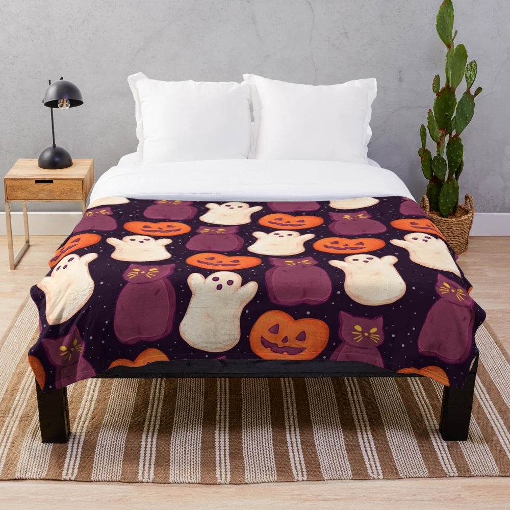 Soft, cozy plush blanket with a spooky marshmallow and pumpkin print design
