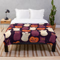 Soft, cozy plush blanket with a spooky marshmallow and pumpkin print design