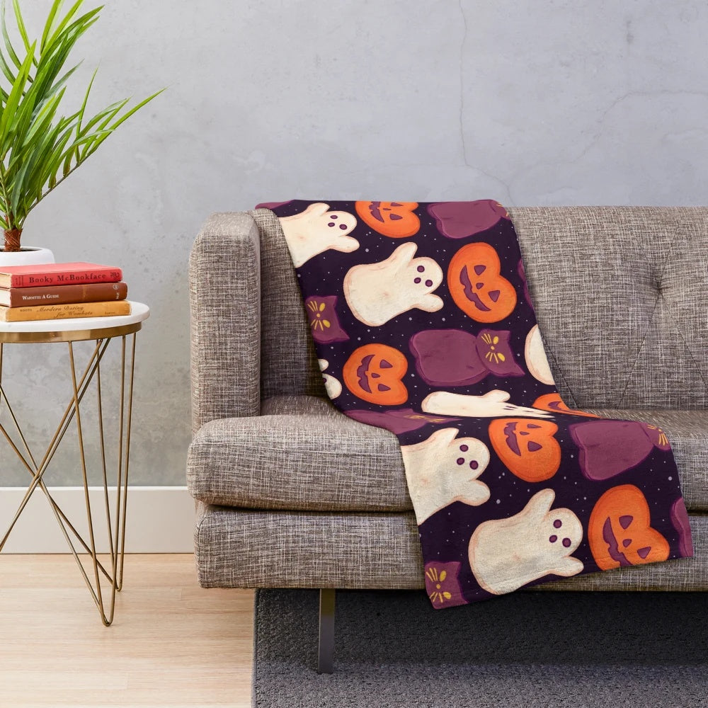 Soft, cozy plush blanket with a spooky marshmallow and pumpkin print design