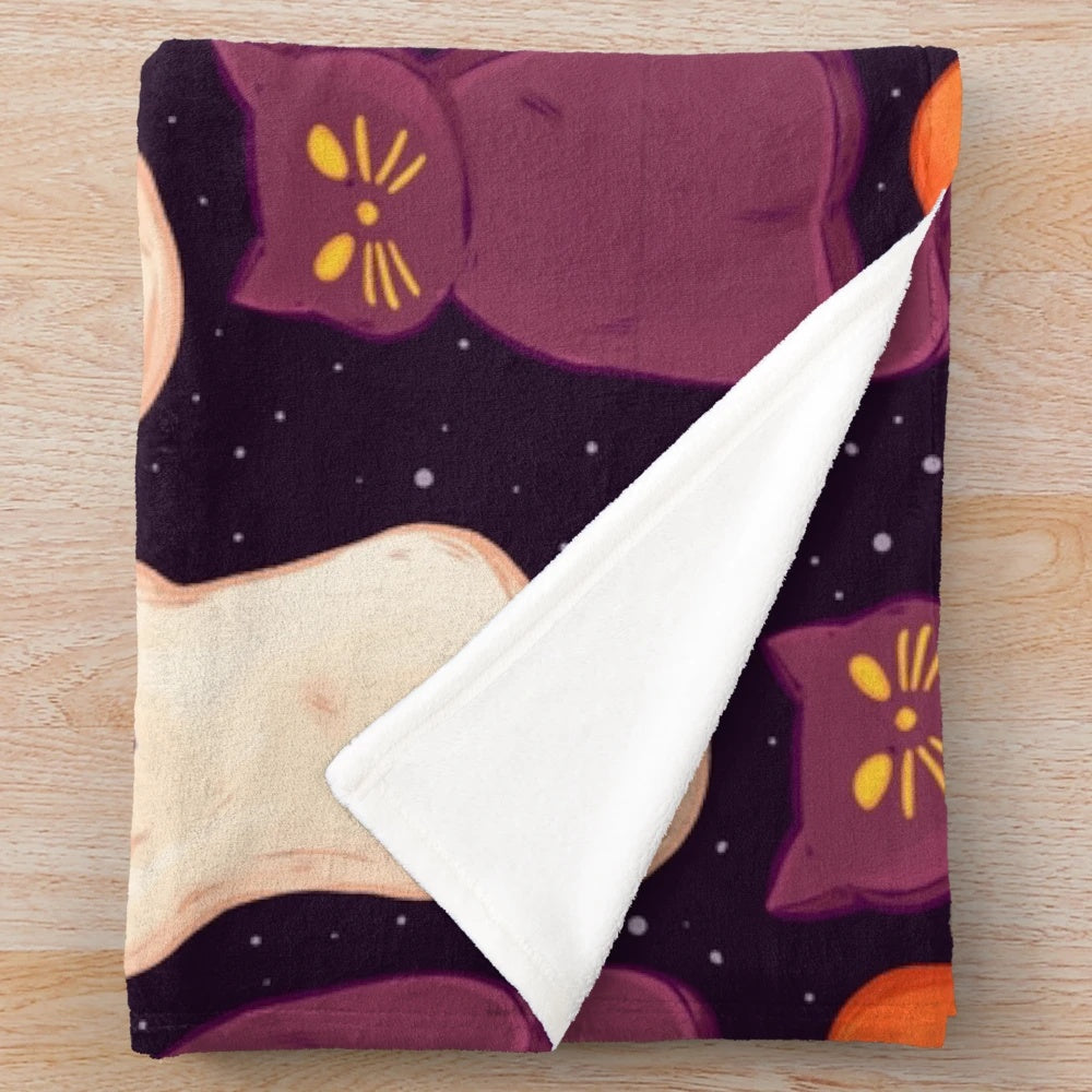 Soft, cozy plush blanket with a spooky marshmallow and pumpkin print design