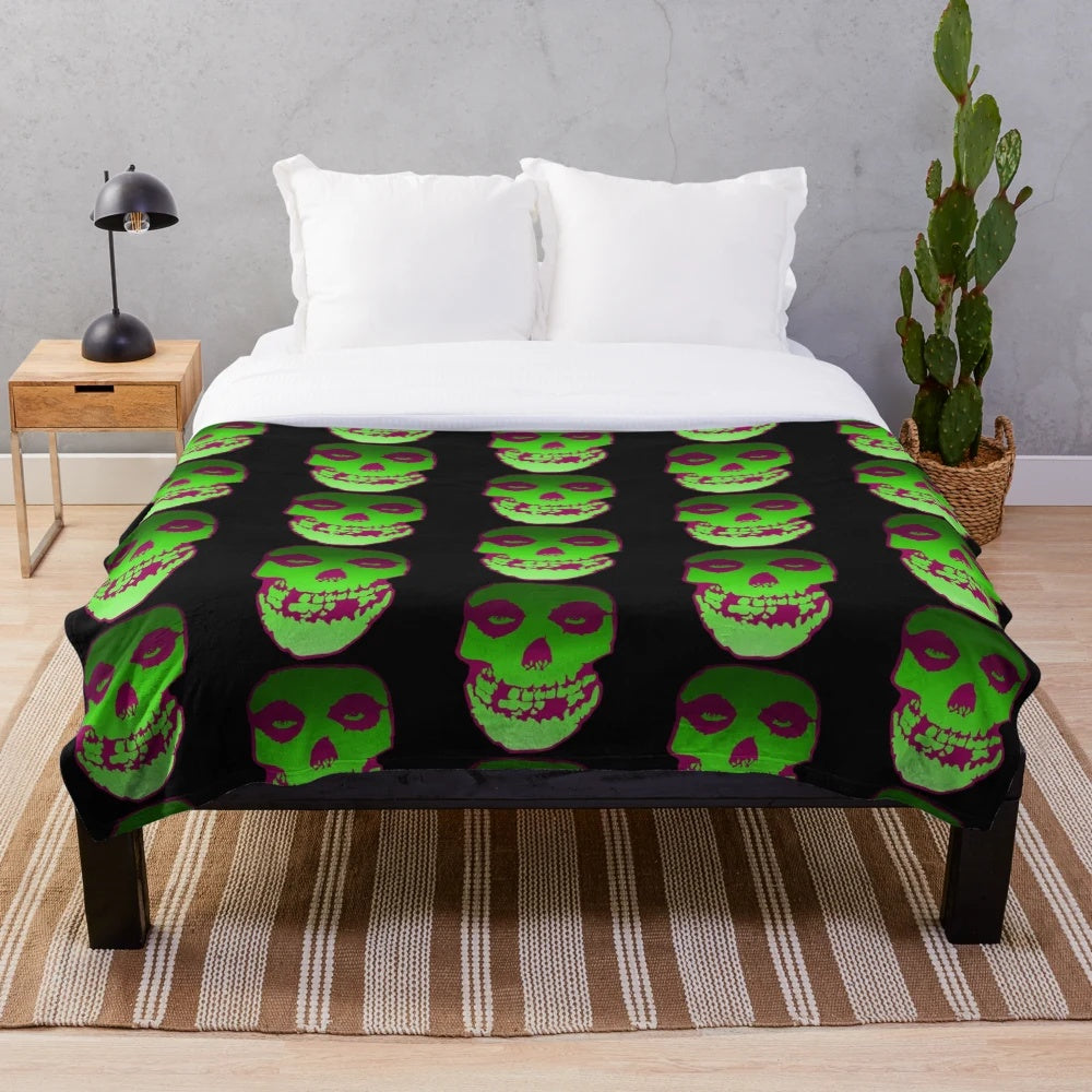 Misfit-inspired plush blanket featuring a skull design