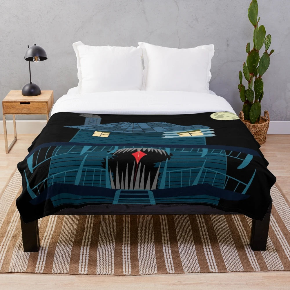 Plush blanket featuring a spooky monster house under the moonlight