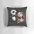 A decorative pillow featuring the characters Jack Skellington and Sally from the Nightmare Before Christmas.