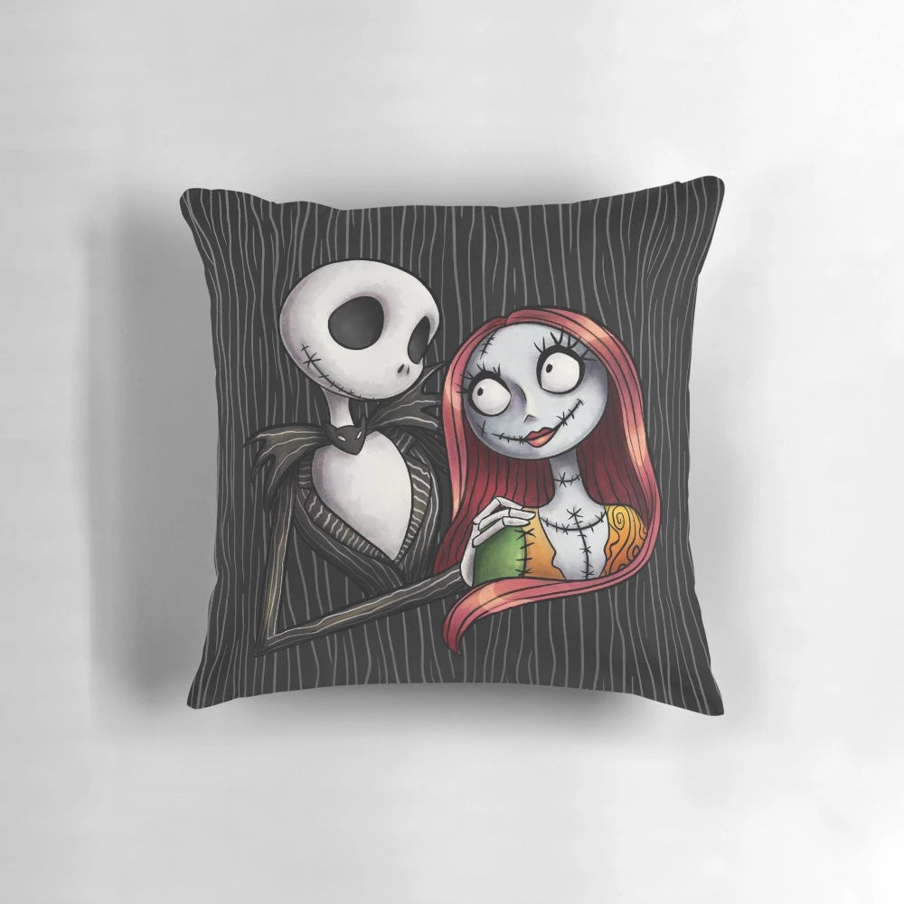 A decorative pillow featuring the characters Jack Skellington and Sally from the Nightmare Before Christmas.