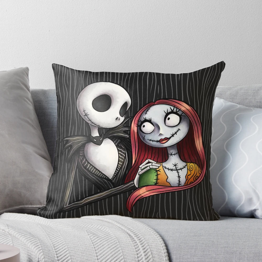 A decorative pillow featuring the characters Jack Skellington and Sally from the Nightmare Before Christmas.