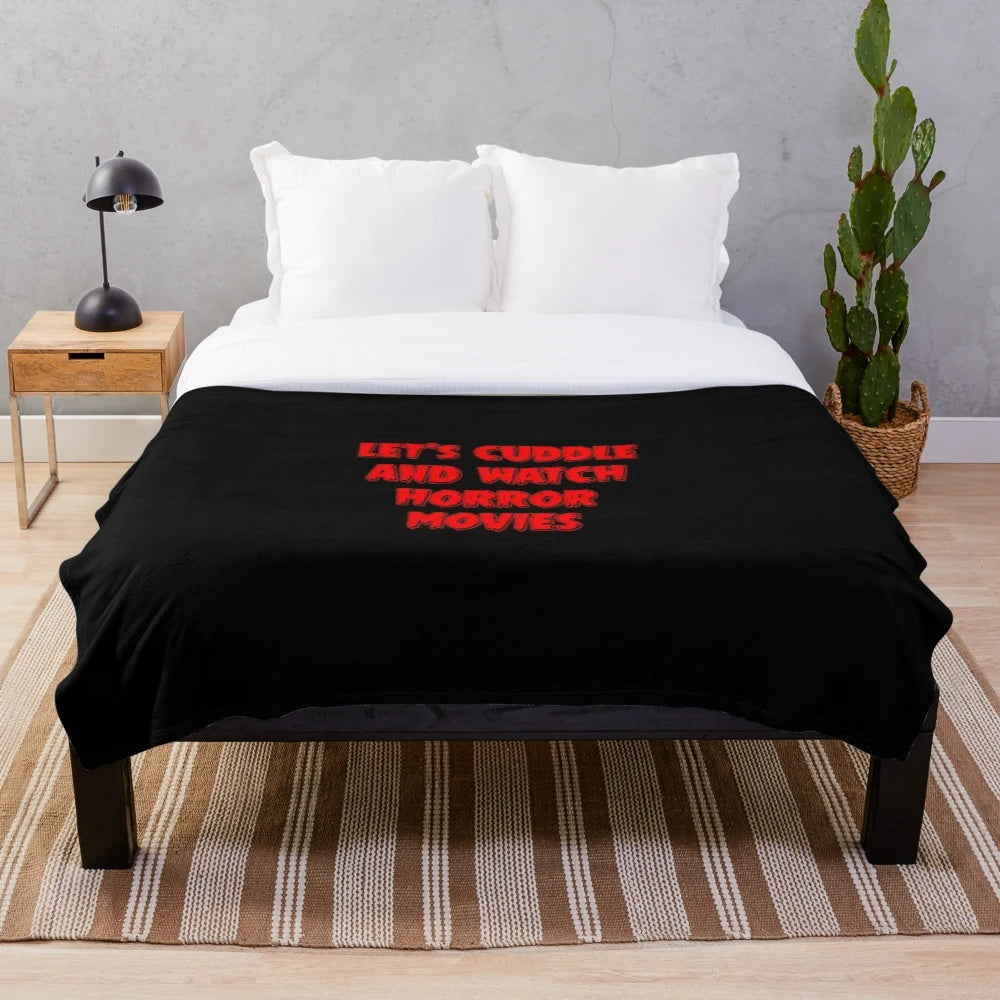 A cozy plush blanket with a horror movie theme, perfect for cuddling and watching scary movies.