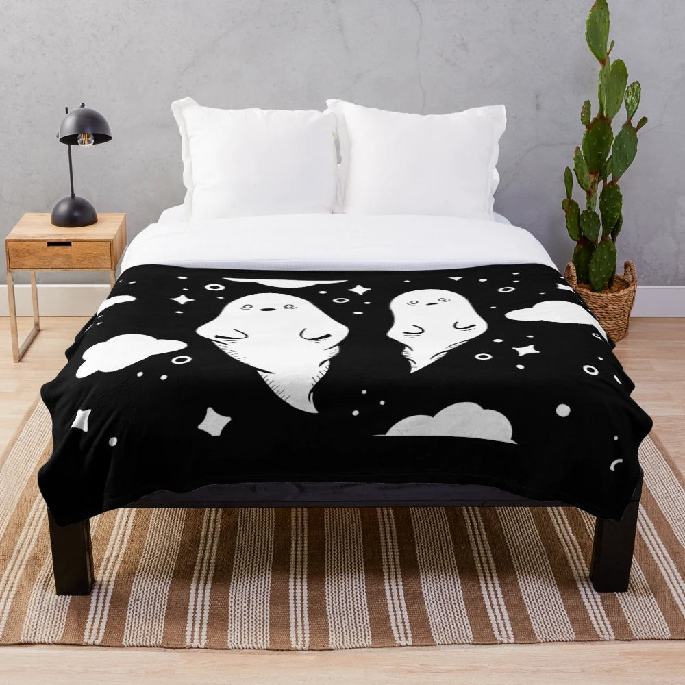 Soft and cozy plush blanket featuring adorable black and white ghosts
