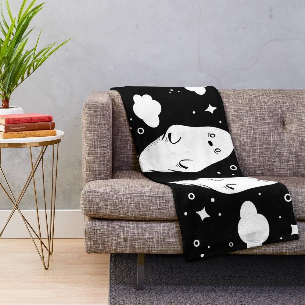 Soft and cozy plush blanket featuring adorable black and white ghosts