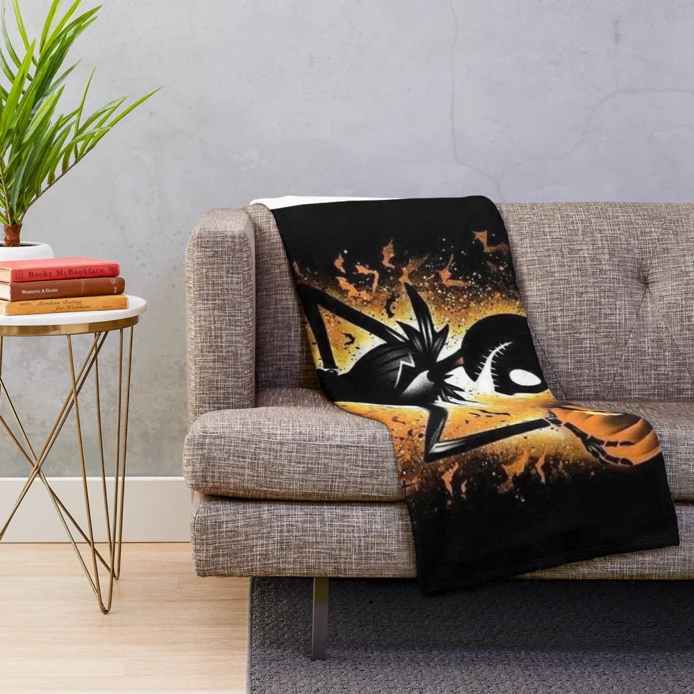 Cozy plush blanket featuring a spooky skeleton and pumpkin design