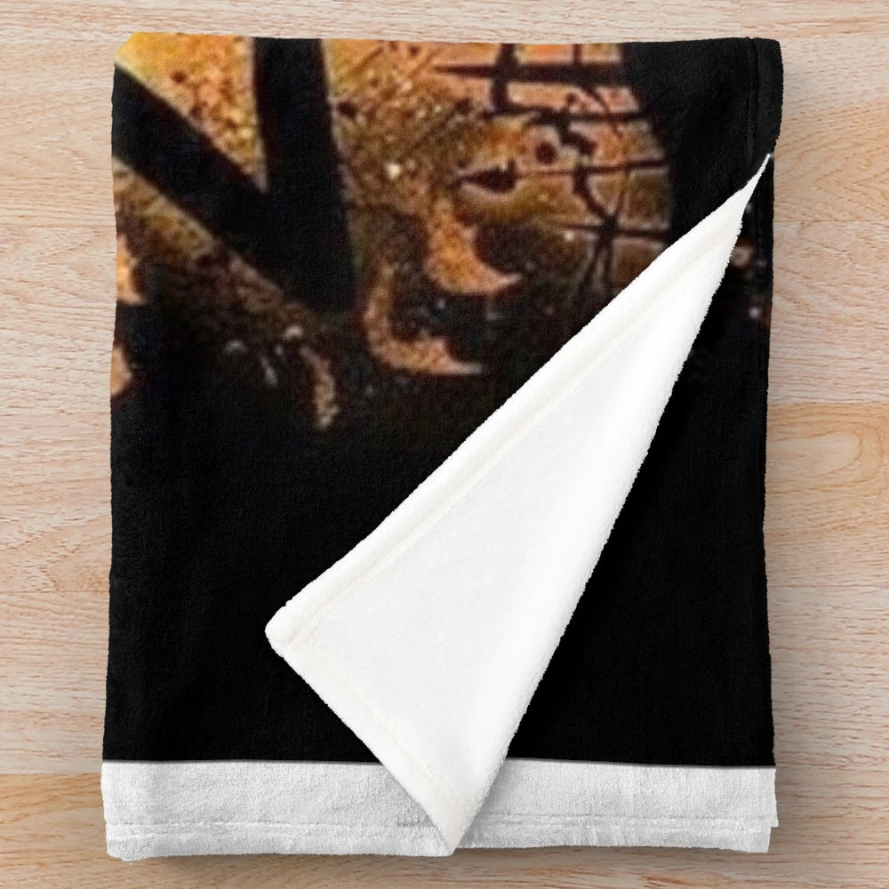 Cozy plush blanket featuring a spooky skeleton and pumpkin design
