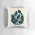 A decorative pillow featuring a watercolor illustration of a raven perched on a branch against a nighttime sky.