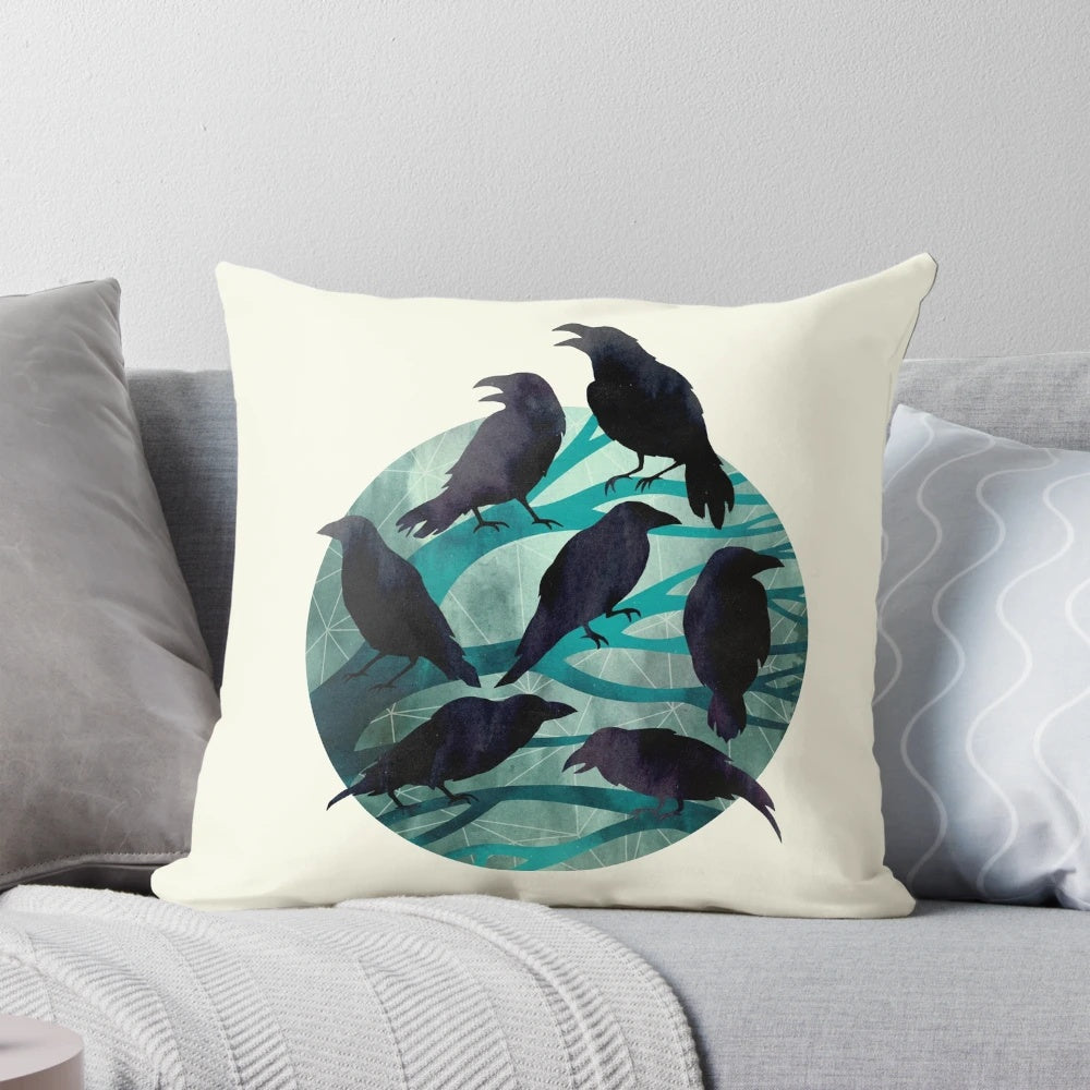 A decorative pillow featuring a watercolor illustration of a raven perched on a branch against a nighttime sky.